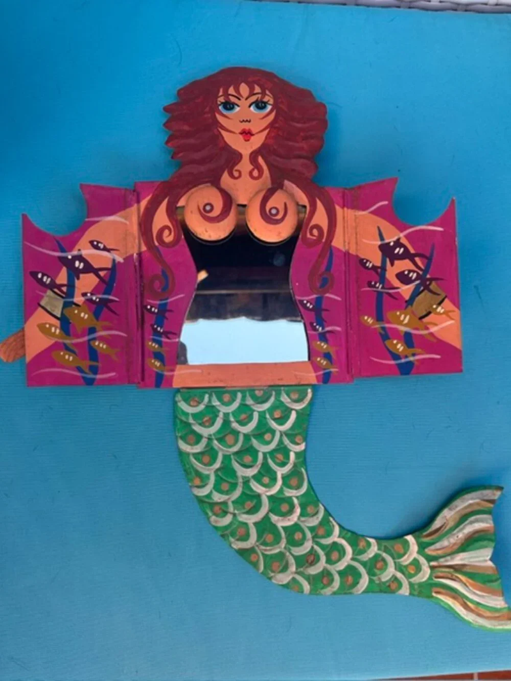 Redheaded painted tin mermaid with chest drawers that open to a mirror.
